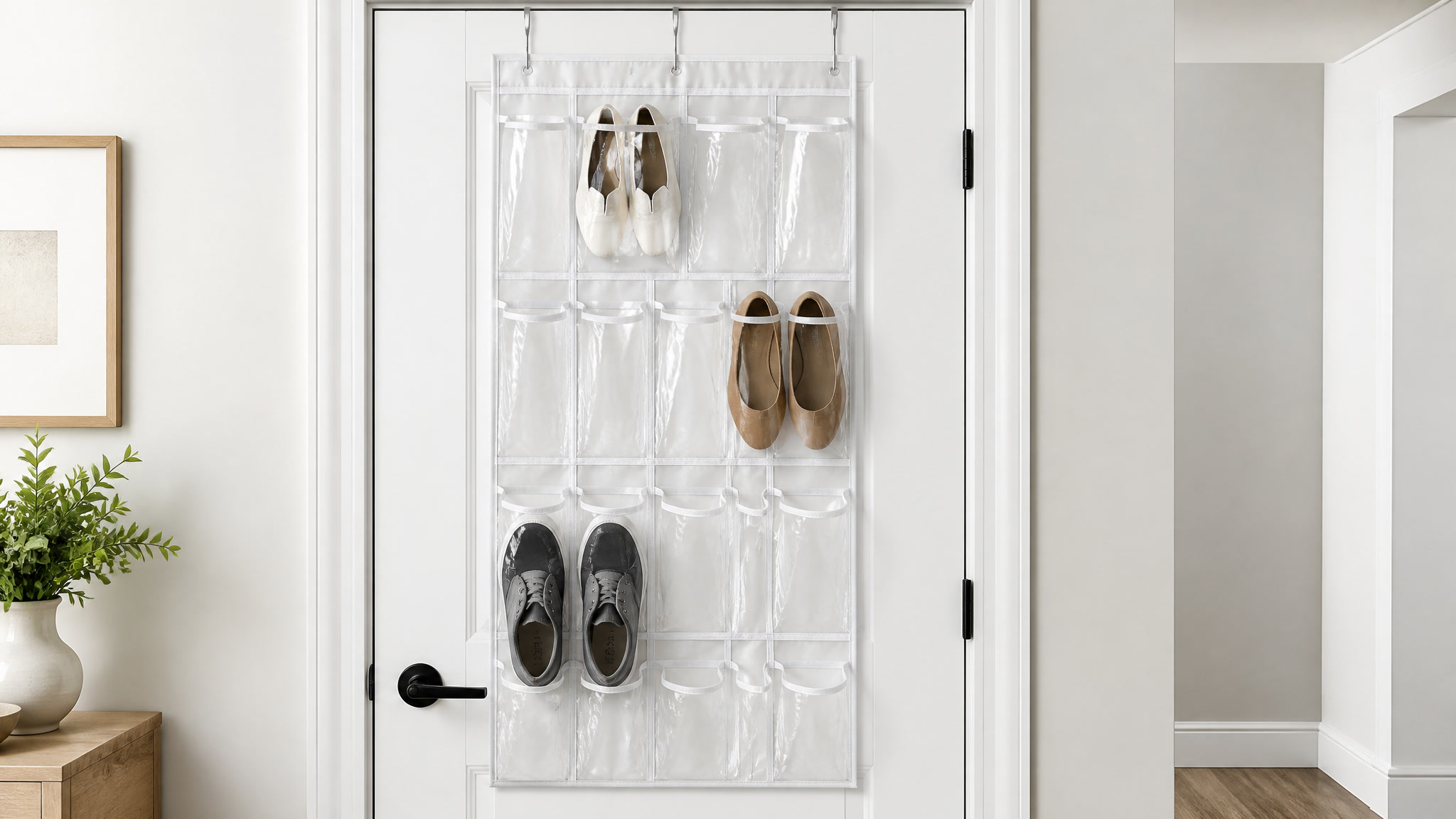 Over-the-door organizer with clear pockets hanging from a white interior door